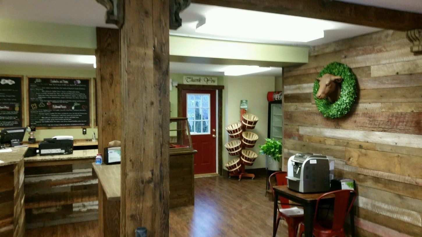 The Farmhouse Cafe dining room, with a wooden sign and tables set for breakfast and lunch