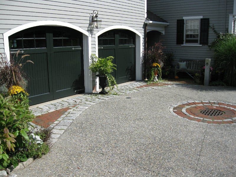 Curved stone steps and a stone retaining wall in a landscaped yard
