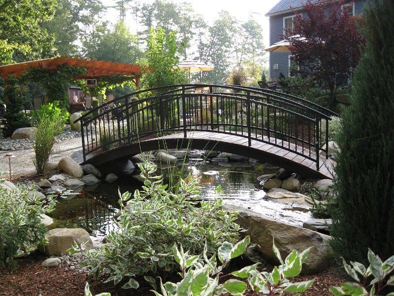 A wooden pergola over a stone patio